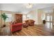 Bright living room features wood-look tile flooring and comfortable seating arrangement at 2096 Callaway Dr, The Villages, FL 32162