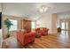 Bright living room features wood-look tile flooring and comfortable seating arrangement at 2096 Callaway Dr, The Villages, FL 32162