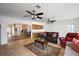 Spacious living room offering tile floors, a comfortable seating arrangement, and an adjacent kitchenette at 2096 Callaway Dr, The Villages, FL 32162