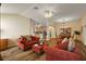 Open-concept living room showcasing wood-look tile flooring and a seamless flow to the kitchen at 2096 Callaway Dr, The Villages, FL 32162