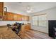 Bright home office featuring hardwood floors, built-in desk, cabinets, and natural light at 2096 Callaway Dr, The Villages, FL 32162