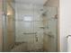Shower with glass doors, built-in seat, and grab bars at 2096 Callaway Dr, The Villages, FL 32162