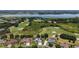 Picturesque aerial view of the home, golf course, and lake, showcasing the property's prime location at 2125 Horizon Run, The Villages, FL 32162
