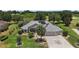 Aerial view of a home with solar panels, a golf course view, and lush landscaping at 2125 Horizon Run, The Villages, FL 32162