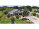 An aerial view of home, showcasing its solar panels, mature landscaping, and golf course view at 2125 Horizon Run, The Villages, FL 32162
