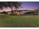 Inviting backyard with a screened-in pool, patio, and outdoor lighting at 2125 Horizon Run, The Villages, FL 32162