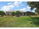 Spacious backyard with lush landscaping, screened-in pool and patio, perfect for outdoor enjoyment at 2125 Horizon Run, The Villages, FL 32162