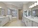 Bright bathroom with double vanities, soaking tub, and tiled shower at 2125 Horizon Run, The Villages, FL 32162