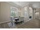 Elegant dining room featuring a chandelier, wood floors, and natural light from the window with shutters at 2125 Horizon Run, The Villages, FL 32162