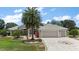 Charming single-story home with a three-car garage, a patterned driveway, and mature landscaping at 2125 Horizon Run, The Villages, FL 32162