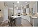 Bright and airy kitchen with white cabinets, a center island, stainless steel appliances, and stylish lighting fixtures at 2125 Horizon Run, The Villages, FL 32162
