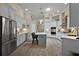 Bright kitchen showcasing white cabinetry, center island, stainless appliances, and contemporary pendant lights at 2125 Horizon Run, The Villages, FL 32162