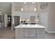 Well-lit kitchen with modern white cabinets, a marble island, and stainless steel appliances at 2125 Horizon Run, The Villages, FL 32162
