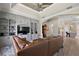 Spacious living room featuring custom built-ins, a large TV, and an inviting leather couch at 2125 Horizon Run, The Villages, FL 32162