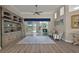 Bright and airy living room featuring a built-in bookcase and sliding glass doors to the patio at 2125 Horizon Run, The Villages, FL 32162