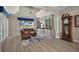 Cozy living room with built-in bookshelves, a comfortable leather couch, and a view of the outdoors at 2125 Horizon Run, The Villages, FL 32162