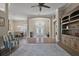 Expansive living room with a view of the dining area and entryway featuring a gorgeous chandelier at 2125 Horizon Run, The Villages, FL 32162