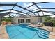 Private screened pool and patio area with a spa, lounge chairs and beautiful outdoor space at 2125 Horizon Run, The Villages, FL 32162