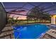 Beautiful screened-in pool and patio with lights, overlooking a well-manicured golf course at 2125 Horizon Run, The Villages, FL 32162
