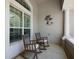 Relaxing porch with rocking chairs and view of the landscaped front yard at 2125 Horizon Run, The Villages, FL 32162