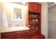 Bathroom vanity featuring a granite countertop and built in shelving on the side of the sink at 21646 Stirling Pass, Leesburg, FL 34748