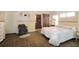 Spacious bedroom featuring wood flooring, a large bed, sliding barn door, and bright natural lighting at 21646 Stirling Pass, Leesburg, FL 34748