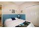 Comfortable bedroom with light blue accent wall, white walls, and a large closet with white doors at 21646 Stirling Pass, Leesburg, FL 34748