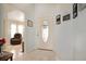 Bright foyer featuring tile flooring, decorative front door with sidelights, and a glimpse into the cozy living area at 21646 Stirling Pass, Leesburg, FL 34748