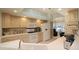 Well-lit kitchen with modern appliances, ample cabinet space, tiled backsplash, and open layout to the living area at 21646 Stirling Pass, Leesburg, FL 34748