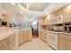 Well-lit kitchen with modern appliances, ample cabinet space, tiled backsplash, and open layout to the living area at 21646 Stirling Pass, Leesburg, FL 34748