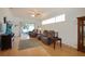 Comfortable living room with hardwood floors, recliner seating, ceiling fan, and plenty of natural light at 21646 Stirling Pass, Leesburg, FL 34748