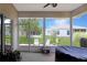 Outdoor patio with screen enclosure offering a serene view of the backyard and neighboring houses at 21646 Stirling Pass, Leesburg, FL 34748