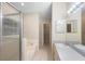 Bright bathroom featuring tiled floors, large vanity, and bathtub with shower at 2304 Clementine Trl, Clermont, FL 34714