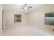 Spacious bedroom with tile floors, ceiling fan, and natural light from multiple windows at 2304 Clementine Trl, Clermont, FL 34714