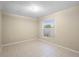 Bright bedroom with neutral paint, tile floors and a window with coverings at 2304 Clementine Trl, Clermont, FL 34714