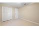 Cozy bedroom with a closet, neutral paint, and light tile flooring at 2304 Clementine Trl, Clermont, FL 34714