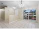 Light and bright dining area featuring neutral walls, tile flooring, and a decorative chandelier at 2304 Clementine Trl, Clermont, FL 34714
