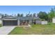 Inviting single-Gathering home featuring landscaped front yard and a two-car garage on a sunny day at 2304 Clementine Trl, Clermont, FL 34714