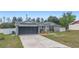 Charming single-story home featuring a well-manicured lawn, brick accents, and an attached two-car garage at 2304 Clementine Trl, Clermont, FL 34714