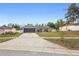 Lovely home boasts a long driveway, attached garage, and neatly landscaped front yard at 2304 Clementine Trl, Clermont, FL 34714