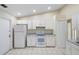Functional kitchen with white appliances, abundant cabinetry, and tile flooring for easy maintenance at 2304 Clementine Trl, Clermont, FL 34714