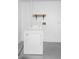 Laundry room area with a white dryer and wooden shelf at 2304 Clementine Trl, Clermont, FL 34714