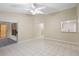 Bright living room with tile flooring, access to screened patio and view of kitchen at 2304 Clementine Trl, Clermont, FL 34714