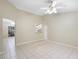 Open floor plan featuring tile flooring and a pass-through window to the kitchen at 2304 Clementine Trl, Clermont, FL 34714