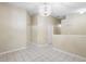 Neutral living room with tile floors, light walls, and a decorative chandelier above at 2304 Clementine Trl, Clermont, FL 34714