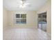 Spacious living room with tile flooring and sliding glass doors to the pool area at 2304 Clementine Trl, Clermont, FL 34714
