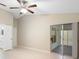 Main bedroom featuring tile flooring, a ceiling fan and access to the screened patio at 2304 Clementine Trl, Clermont, FL 34714