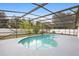 Sparkling screened-in pool surrounded by a large patio area, perfect for outdoor enjoyment and relaxation at 2304 Clementine Trl, Clermont, FL 34714
