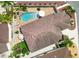 Aerial view of a house showcasing the pool, deck, landscaping, and roof details at 2325 Kenya St, The Villages, FL 32162