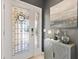 Elegant front door with decorative glass and stylish hardware, complemented by a modern cabinet and tasteful decor at 2325 Kenya St, The Villages, FL 32162